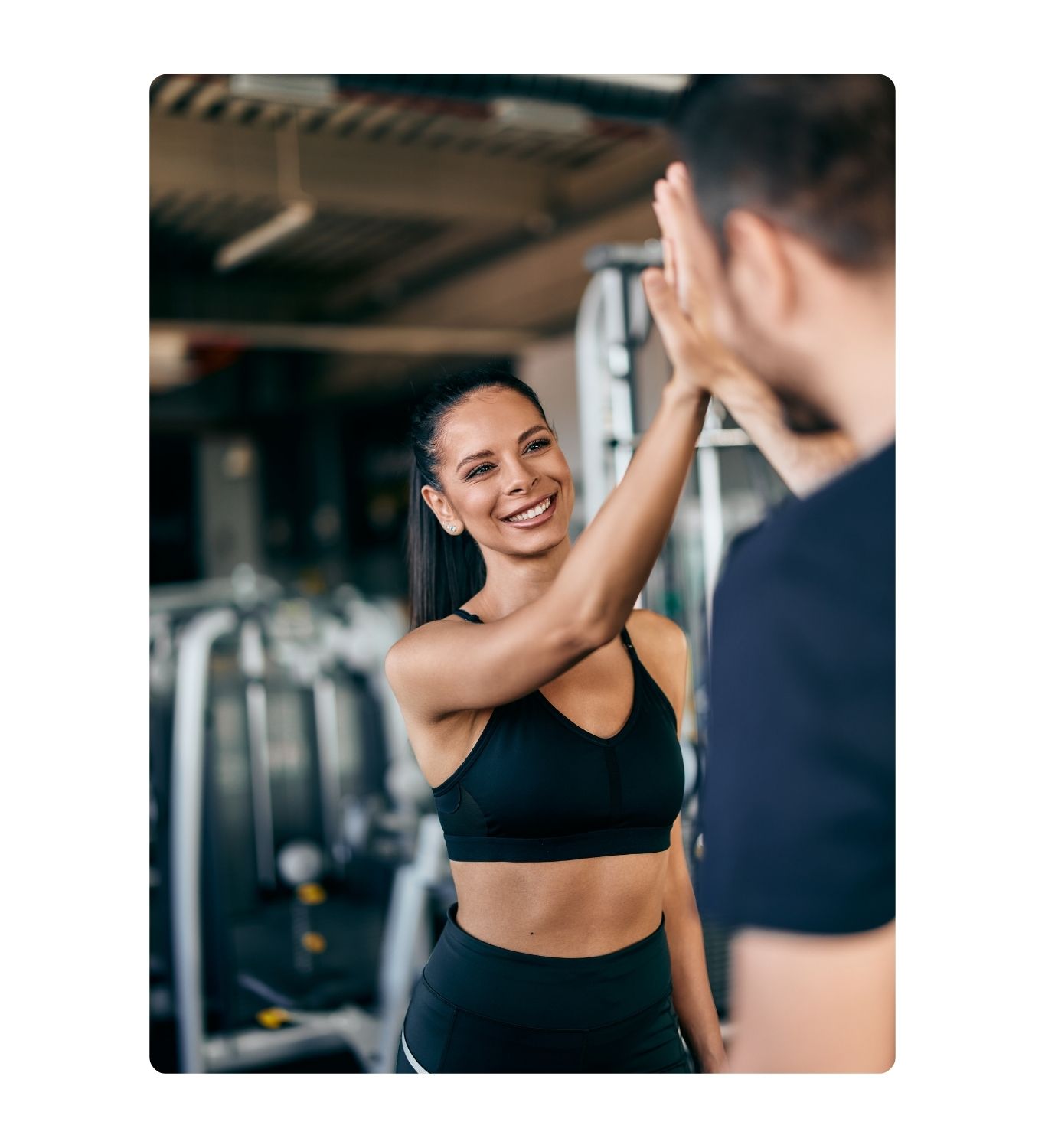 UTF Assets (5) Woman smiling at the gym doing a high five with a man